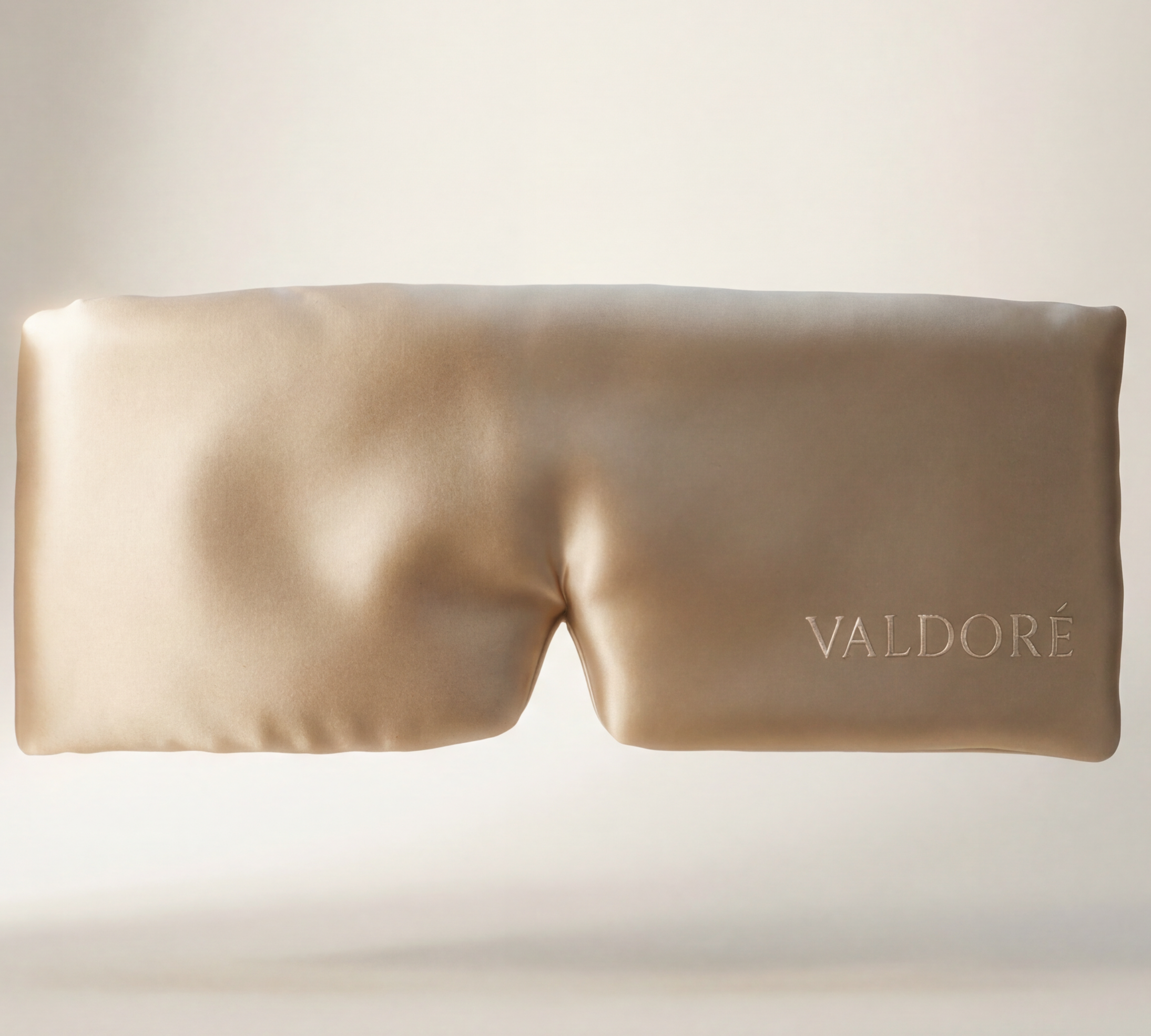 Beige eye mask with 'VALDORE' branding on a light gray background